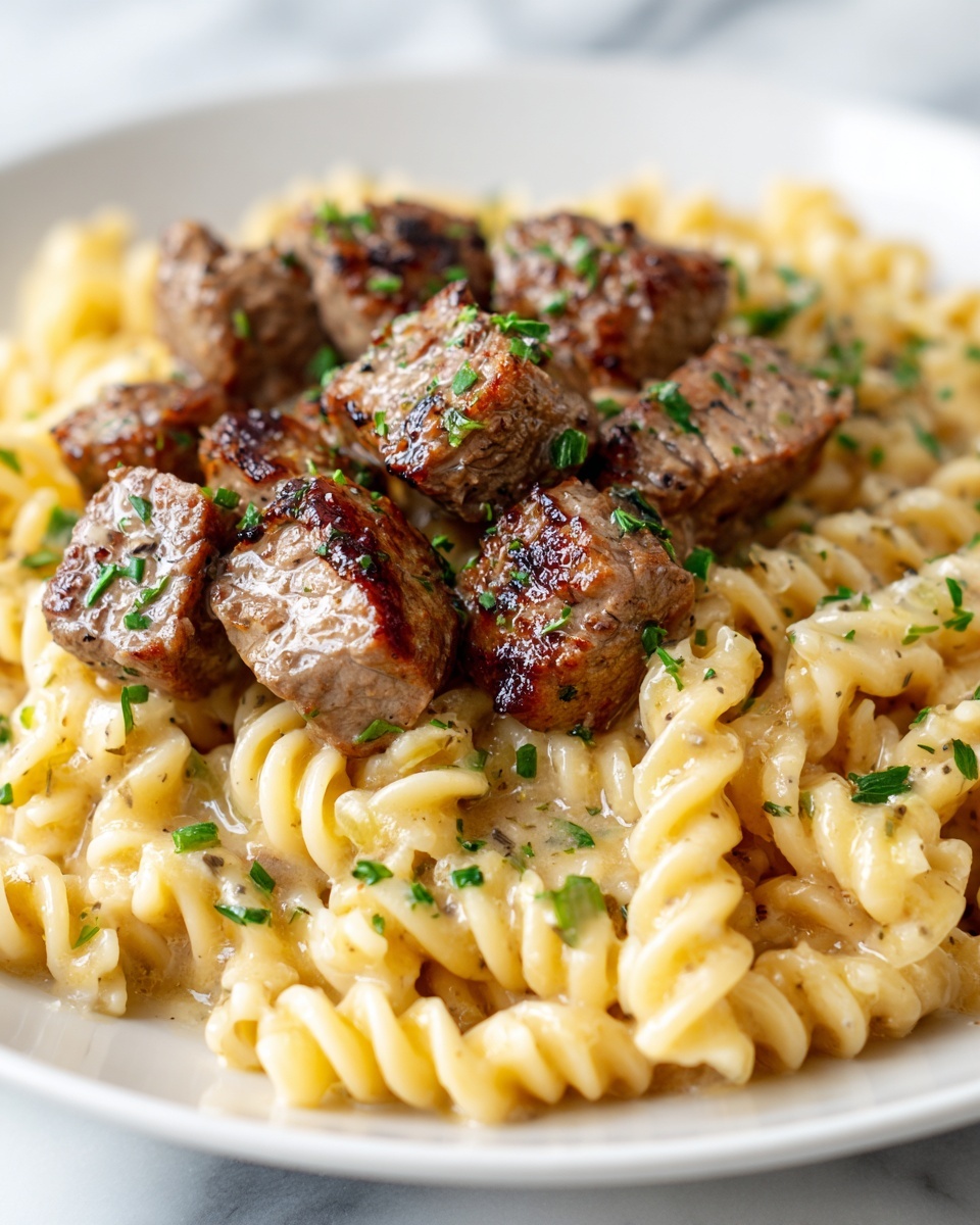 Steak Bites and Cheesy Rotini in Garlic Parmesan Sauce Recipe - Recipe Image