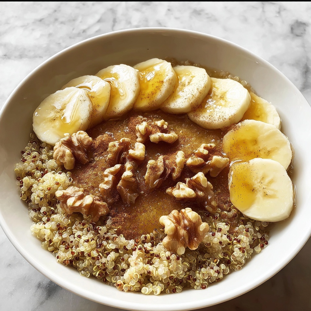 Warm Quinoa Breakfast Bowl with Banana, Walnuts, Honey, and Cinnamon Recipe - Recipe Image